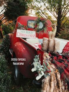 an old red truck is decorated for christmas