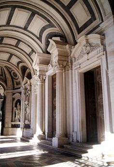 the interior of an old building with columns and arches