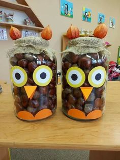 two jars filled with nuts sitting on top of a table