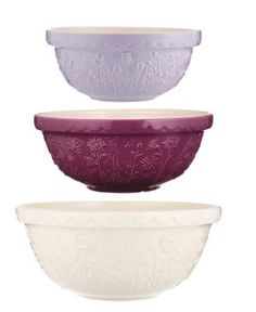 three bowls are stacked on top of each other, one is purple and the other has white