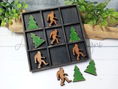 wooden cutouts of different sizes and shapes in a box with plants on the side