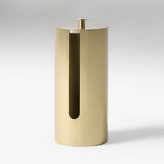 a gold colored metal container with a black handle on the top and bottom, in front of a white background