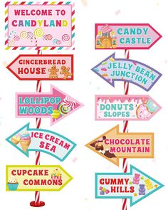 various signs are hanging from the side of a pole with candy land written on them