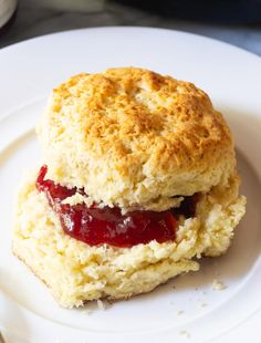 a biscuit with jam is on a white plate