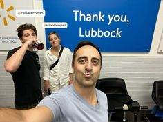 a man taking a selfie in front of a blue sign with the words thank you, lubbock