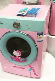 a hello kitty washing machine is on display at a store in the usa, it's pink and blue