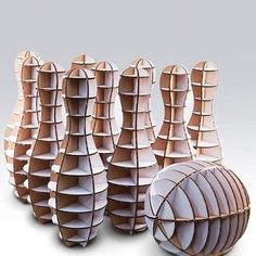 several vases made out of cardboard sitting next to each other