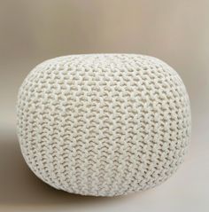 a white knitted ball sitting on top of a table