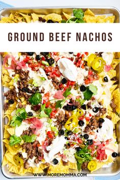 a tray filled with nachos covered in cheese and toppings next to the words ground beef nachos