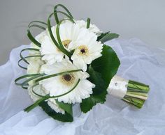 a bouquet of white flowers sitting on top of a table