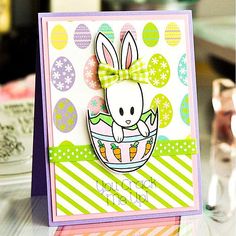 a close up of a card with an easter bunny in a basket on the front