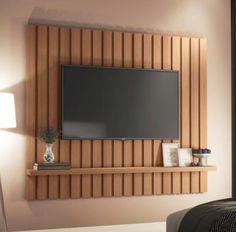 a flat screen tv mounted to the side of a wooden wall above a bed in a bedroom