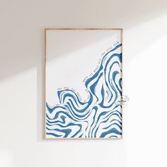 a blue and white painting hanging on the wall