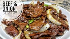 beef and onion stir fry on a white plate