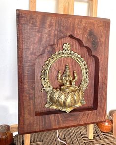 an intricately carved wooden frame with a gold gandap on it's side