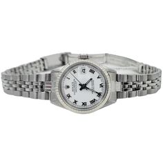 Women's Rolex 26mm DateJust Stainless Steel Watch with White Dial and Fluted Bezel. Pre-Owned SN# 148***** Brand: Rolex. Crystal: Plastic. Dial Color: White. Gender: Women's. Bezel: Fluted Bezel. Condition: Excellent. Dial: Roman Numeral. Bracelet / Strap: Jubilee. Movement: Self-Winding. Case Dimensions: 26mm. Metal Type: Stainless Steel. Service Date: Fully Serviced on 03/20/2023. Box / Certificate: Rolex Box / Certificate of Authenticity. Service Warranty: One (1) Year Limited Service Warrant Classic Watches With Jubilee Bracelet And Round Dial, Classic Watches With Jubilee Bracelet, Timeless White Watch With Stainless Steel Clasp, Timeless White Gold Watch Band With Stainless Steel Clasp, White Watch Accessories With Stainless Steel Clasp, Formal Jubilee Bracelet Watch Accessory, Classic Round Watches With Jubilee Bracelet, Classic Round Watch Bands With Stainless Steel Clasp, Formal White Gold Watch Band With Stainless Steel Clasp