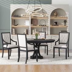 a dining room table with four chairs and a bookcase in the back wall behind it