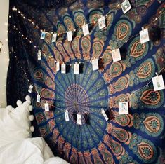 there is a large blue and orange tapestry hanging on the wall with tags attached to it