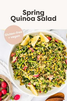 a white bowl filled with quinoa salad next to wooden spoons and utensils