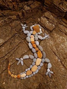 a lizard made out of rocks sitting on top of a rock