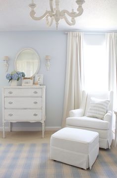 a white chair and ottoman in a room