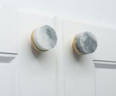 two marble knobs are on the white door