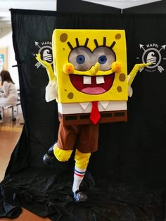 spongebob is standing in front of a black backdrop