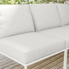 a white couch sitting on top of a wooden floor