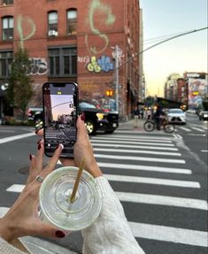 a woman taking a selfie with her cell phone on the street in new york city