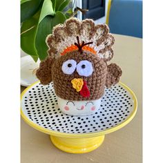 a crocheted turkey sitting on top of a plate