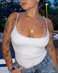 a woman with tattoos on her arms and chest