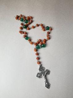 "This set of Lutheran prayer beads is wired on Stainless steel eye pins. It features Rudraksha seeds, green Malay Jade, and a detailed, well-made Pardon crucifix. This rosary is hand-wired using silver-toned stainless steel eye pins and my trusty little looper tool. The smaller beads are 6mm Rudraksha seeds. Rudraksha seeds are used for making Buddhist and Hindu malas. More info on the history of Rudraksha seeds will be added below. The larger beads are 10mm dark green Malay jade beads. Malay ja Green Spiritual Jewelry For Puja, Spiritual Rosary With Polished Beads For Healing, Spiritual Rosary With Polished Beads As Gift, Spiritual Wire Wrapped Rosary As Gift, Spiritual Rosary With Polished Beads For Meditation, 108 Beads Cross Rosary For Meditation, Spiritual Crucifix Rosary As Gift, Gift Rosary With Polished Beads And Cross, Gift Rosary With Polished Beads