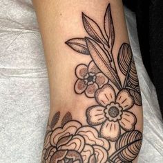 a black and white flower tattoo on the foot