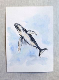 a watercolor painting of a humpback whale