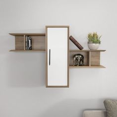 a white wall with some books on it and a pen in the middle, next to a book shelf