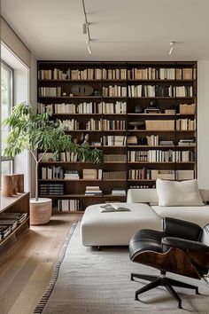 a living room filled with furniture and bookshelves covered in lots of bookcases