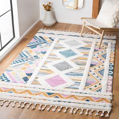 a multicolored rug with tassels on the floor