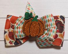 This cute single bow is perfect for you or your child's hair. 🎀 Welcome to BowBeesDesign 🐝  This listing is for 1 Thanksgiving bow, great for any occasion.  Quantity:  1 Dimensions:  4" wide x 3" tall Features: Layered grosgrain ribbon. Topped with a cute pumpkin feltie center. Attached with a grosgrain ribbon lined alligator clip. One of a kind! I am a small business with a passion for crafting and I appreciate each and every order. Thanks for looking at my Etsy store. Laura Taylor BowBeesDesign Turkey Bow, Thanksgiving Hair Bows, Thanksgiving Bow, Pumpkin Hair, Thanksgiving Hair, Handmade Hair Bows, Baby Bow, Cute Hair, Cute Pumpkin