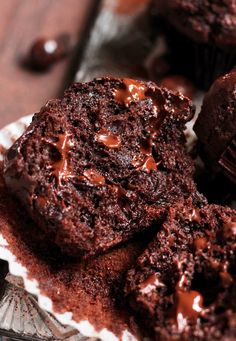 some chocolate cupcakes are sitting on a plate