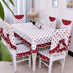 a dining room table covered in polka dot fabric with matching chairs and bench covers for the seats