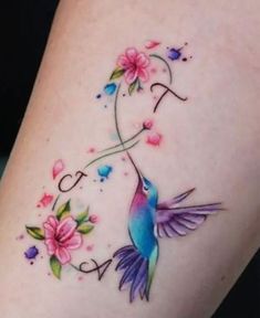 a colorful hummingbird tattoo on the thigh