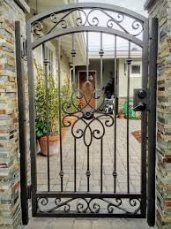 an iron gate in front of a brick house