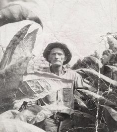 an old photo of a man standing in front of a giant bird