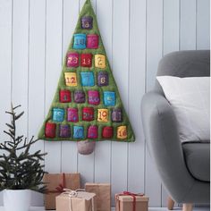 a christmas tree made out of felt with numbers on it and presents under the tree