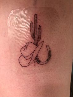 a tattoo on the side of a woman's leg with a cactus and heart