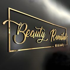 a black and gold sign with the words beauty revealed on it's side, in front of a dark background