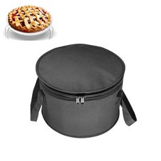 a pie sitting on top of a white plate next to a black lunch bag with the lid open