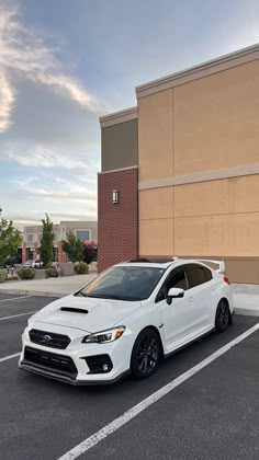 a white car parked in front of a building