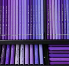 several rows of purple colored pencils on display