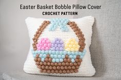 a crocheted pillow with an easter basket on it